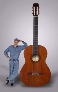 Man standing next to an enlarged guitar