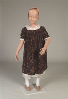 Image of a child's brown printed cotton frock circa 1810 to 1811.